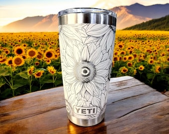 May include: White Yeti tumbler with a black and white sunflower design. The tumbler has a stainless steel lid and the Yeti logo is visible on the bottom.
