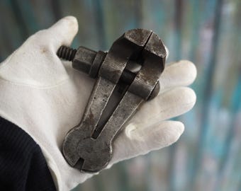 May include: A vintage metal hand vise with a silver finish. The vise is open and ready to clamp.
