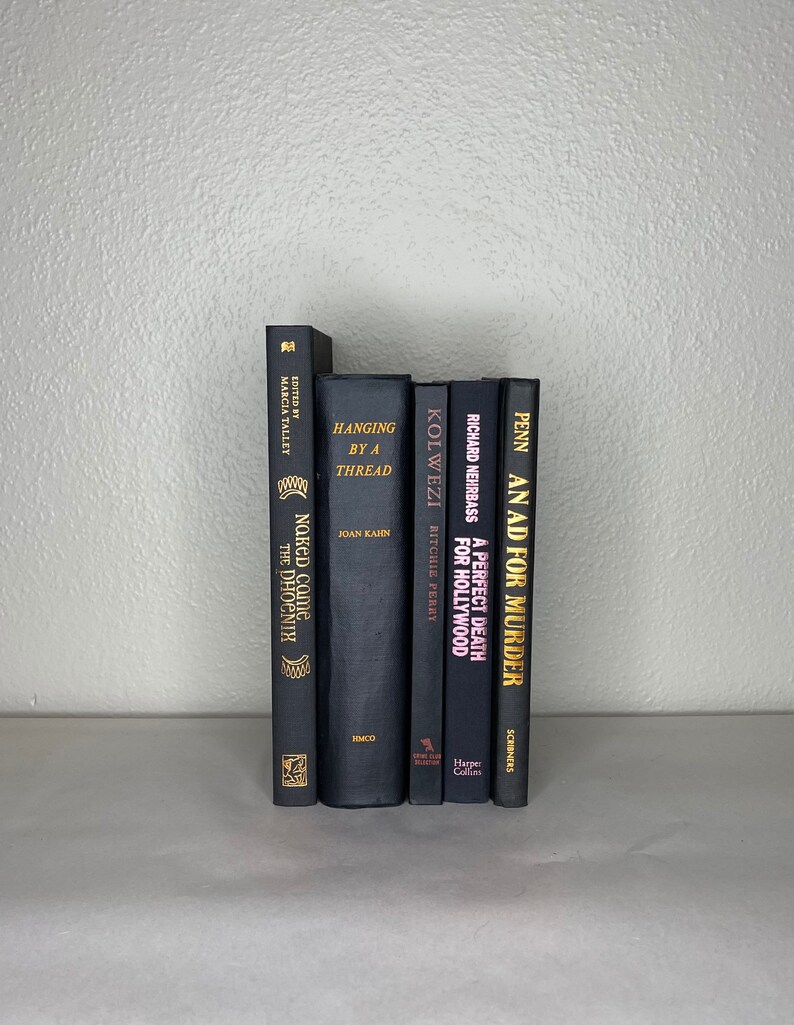 May include: A collection of six hardcover books with dark covers. The titles and authors are visible, including "Hanging by a Thread" and "An Ad for Murder." The spines are in varying shades of black and gray, with gold lettering.