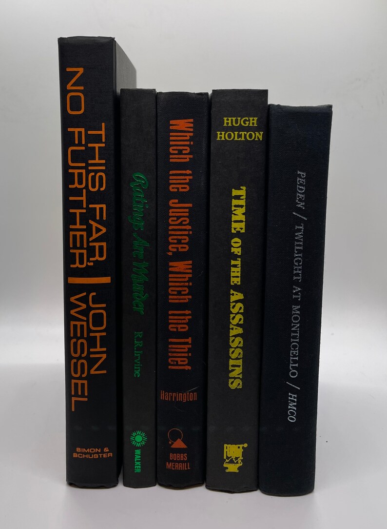 May include: A collection of five hardcover books with black covers. The titles and author names are printed in various colors, including orange, green, and gold. The books are arranged vertically, with the spines facing forward.