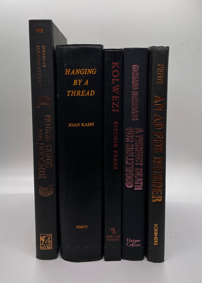 May include: A collection of six hardcover books with black covers and gold or pink lettering. Titles include "Hanging by a Thread" and "A Perfect Death for Hollywood". The books are arranged vertically.