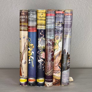 May include: A row of seven vintage children's books with colourful illustrations and titles such as "The Story of Robert E. Lee" and "The Story of Martha Washington".