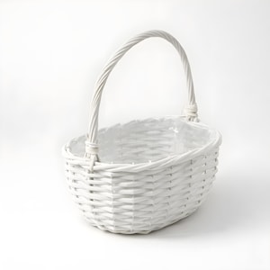 May include: A white wicker basket with a handle. The oval-shaped basket is made of woven wicker and has a sturdy handle. The basket is painted white and is suitable for various uses.