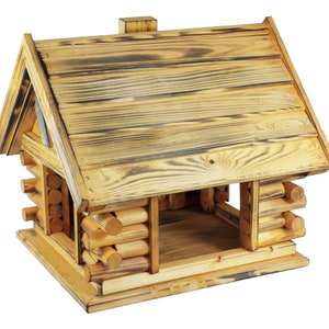 May include: A wooden bird feeder shaped like a small house with a gabled roof. The feeder is made of natural wood with a rustic, weathered look. The feeder has a large opening in the front for birds to access the food.
