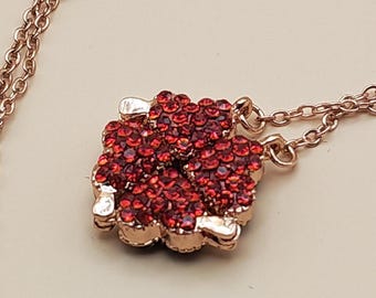 Shape Morphing Necklace pendant, composed of 4 smaller hearts magnetically held together.