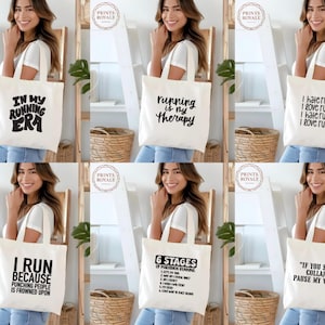 May include: A collection of white canvas tote bags with various black text designs. The designs include phrases like "In My Running Era," "Running is My Therapy," and humorous running quotes. The bags are held by a person.