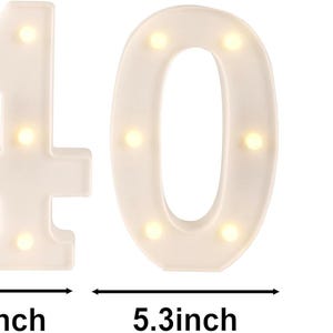 May include: White illuminated number 40 with warm white lights, 8.5 inches tall, 5.9 and 5.3 inches wide. A red soda can, 2.48 inches tall, is next to the numbers. Ideal for birthday celebrations or milestone events.