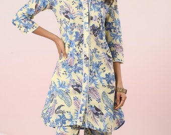 May include: A yellow and blue floral print two-piece outfit. The top has a collared neckline and long sleeves. The pants are wide-legged and cropped.