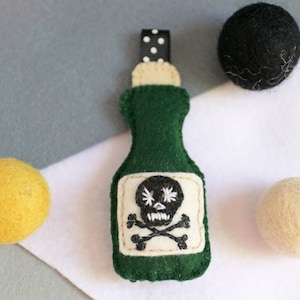 Funny bottle with poison felt. Cute keychain or backpack accessory.