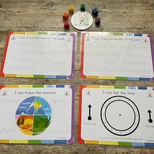 May include: Four colourful laminated cards with rainbow borders. Each card has a different theme: days of the week, months of the year, seasons, and telling time. The cards have black and white text and illustrations.