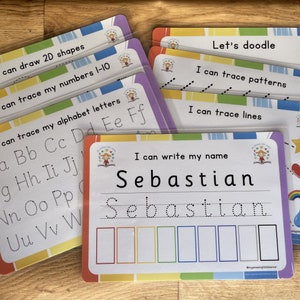 May include: A set of colourful laminated learning cards for children. The cards feature activities such as tracing letters, numbers, and shapes, as well as writing their name. The cards have a fun and engaging design with colourful borders and illustrations.