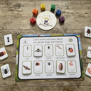May include: A colourful educational game for children featuring a matching activity with pictures of garden bugs and insects. The game includes cards with pictures of an ant, bee, beetle, caterpillar, ladybird, moth, snail, spider, woodlouse, and worm. The game also includes a board with the names of the bugs and insects.