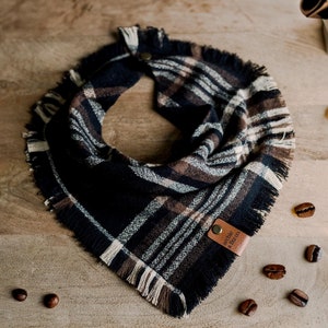 May include: A black, brown, and white plaid bandana with frayed edges and a brown leather tag that says "Special Blend Co."