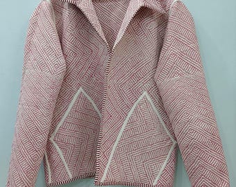 May include: A long-sleeved jacket featuring a repeating geometric pattern in red and white. The garment has a wide collar, a front opening, and two large triangular pockets on the front. The edges are finished with a thin white trim throughout.