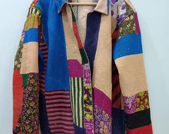 May include: A long-sleeved jacket constructed from various quilted fabric patches in vibrant colors including blue, red, purple, and beige. The garment features a collared neckline, a button-down front, and intricate kantha-style stitching throughout.