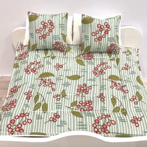 Dolls house comforter or quilt and pair of cushions 16th scale.