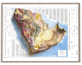 May include: A framed geologic map of the Arabian Peninsula. The map shows a 3D relief, with pink, yellow, and brown terrain. The map is set against a light blue sea, with detailed text and a wooden frame.