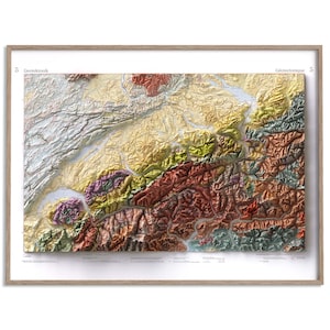 May include: A framed geological map featuring a textured, three-dimensional relief of a mountain range. The map displays varied terrain in shades of red, green, yellow, and grey, with the text "5 Geotektonik" and "Géotectonique 5" at the top.