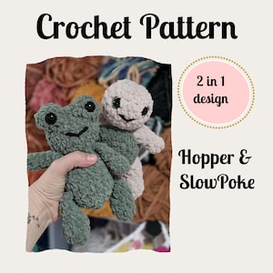 May include: Crochet pattern featuring two plush toys: a green frog and a light pink turtle. The text "Crochet Pattern" is at the top, with "2 in 1 design" and "Hopper & SlowPoke" below. The toys are held in a person's hand.