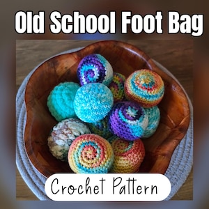 May include: A collection of round, multi-colored crocheted foot bags in a wooden bowl. The text 'Old School Foot Bag' appears at the top, and 'Crochet Pattern' is at the bottom. The items feature various yarn colors including teal, purple, orange, and yellow.