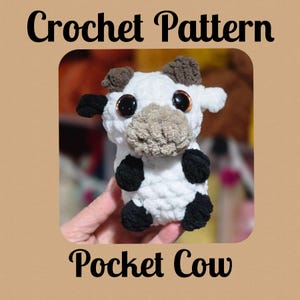 May include: Crochet pattern for a white pocket cow with black spots and brown ears. The cow has large brown eyes and a brown nose.