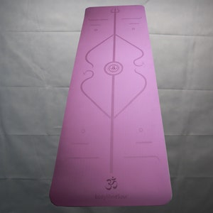 May include: Pink yoga mat with a white design featuring a symbol and the words "Easy Mind Soul".