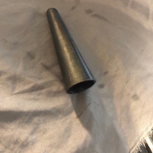 May include: A black, cone-shaped, plastic ring sizing tool.