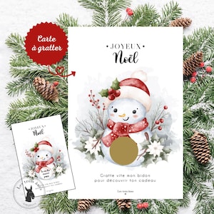 Peut inclure: Carte à gratter de Noël avec un bonhomme de neige en aquarelle, portant un chapeau et une écharpe rouges et blancs. Le texte "JOYEUX Noël" et "Grotte vite mon bidon pour découvrir ton cadeau" sont présents. Une petite carte similaire est visible.