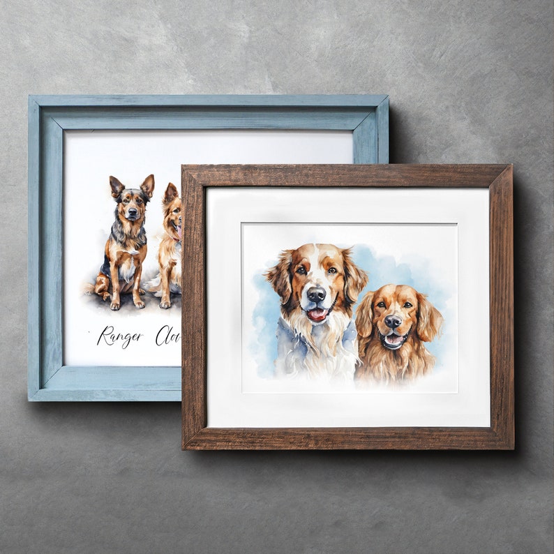 May include: Two framed watercolor portraits of dogs. One frame is light blue, and the other is brown. The portraits feature dogs with brown, white, and black fur. The light blue frame has the text "Ranger Clan" in cursive.