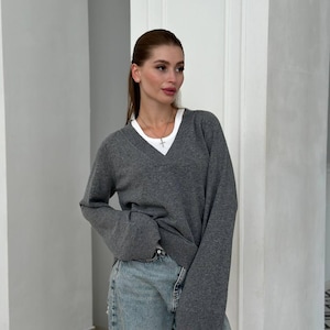 Suéter de cuello en V de lana de cordero gris para mujer