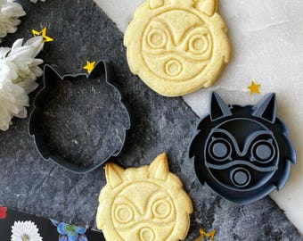 May include: Two cookie cutters and two cookies shaped like a wolf's head with a mask. The cookie cutters are gray and the cookies are light brown.