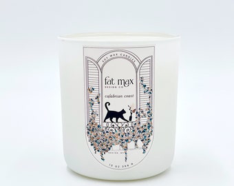 May include: White soy wax candle with a black cat illustration and the text "fat max design co. calabrian coast 13 oz 369 g" on the label.