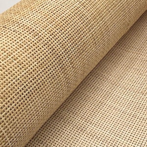 May include: A roll of natural cane webbing, a woven material often used for chair seats and other furniture upholstery.