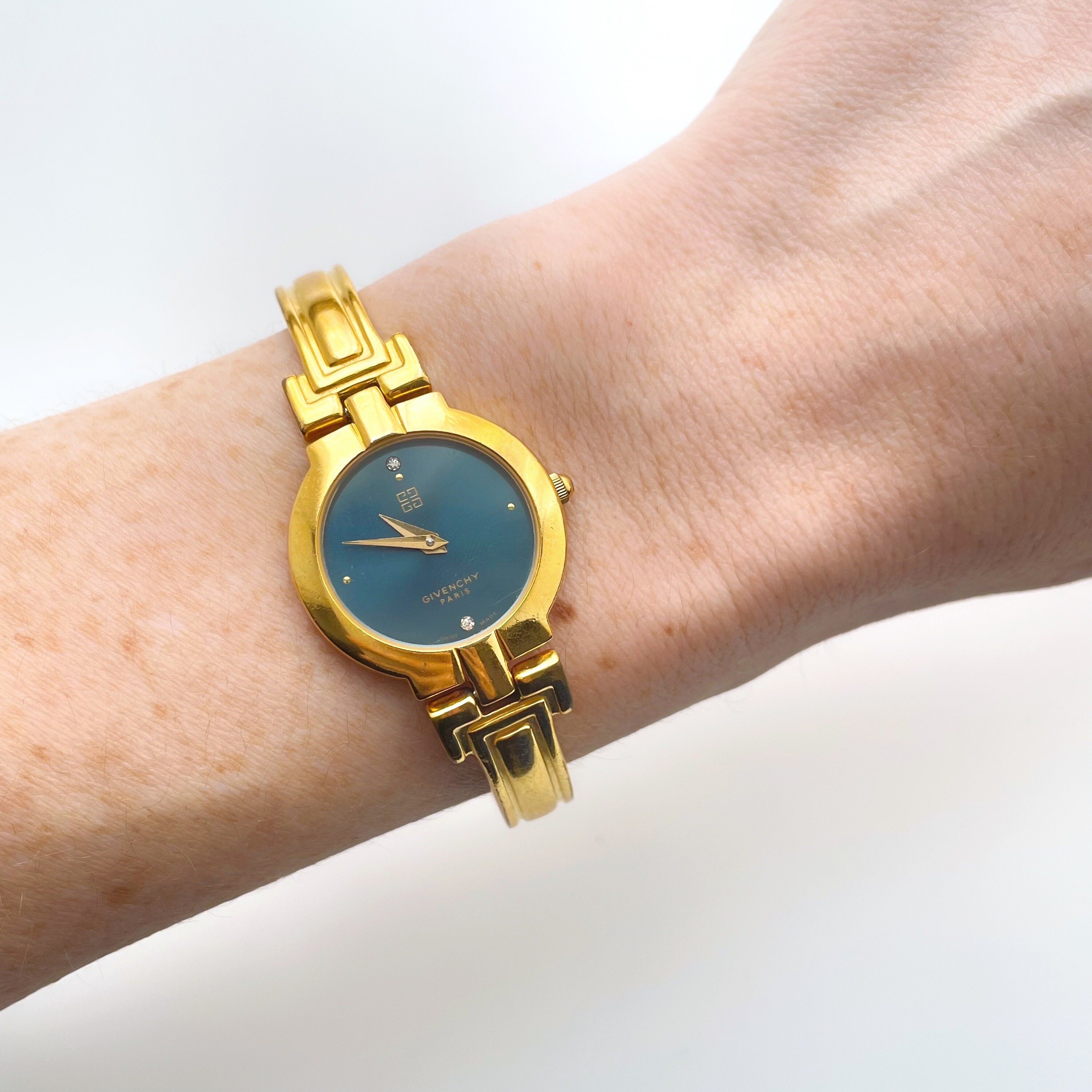 Vintage 1990s Gold Plated Ladies Givenchy Millesime Bangle Watch with Blue Dial and Quartz Movement