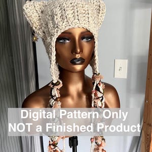 May include: A crochet pattern for a white cat ear hat with long, colorful tassels. The pattern is digital and not a finished product.  Digital Pattern Only NOT a Finished Product.