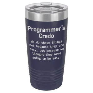 May include: A navy blue stainless steel tumbler with a white inscription that reads "Programmer's Credo" and a quote about the difficulty of programming.