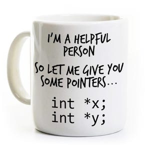 May include: White ceramic mug with a curved handle. The mug features black text that reads "I'M A HELPFUL PERSON, SO LET ME GIVE YOU SOME POINTERS... int *x; int *y;"