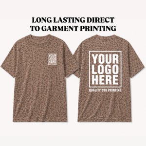 May include: Two brown t-shirts with a leopard print pattern. The front of the shirt has the text "YOUR LOGO HERE" and the back of the shirt has the text "YOUR LOGO HERE QUALITY DTG PRINTING". The text "LONG LASTING DIRECT TO GARMENT PRINTING" is at the top.