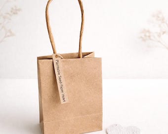Bolsa de papel Kraft ecológica con forma de corazón para regalar con semillas plantables.