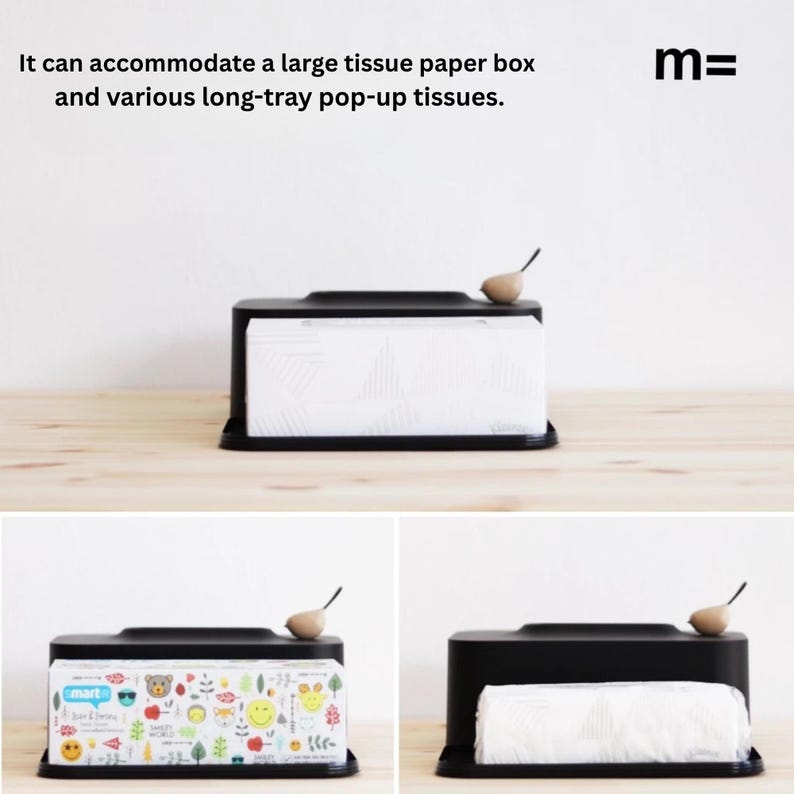 May include: Black tissue box holder with a small wooden bird on top. The holder is designed to accommodate a large tissue box or a long-tray pop-up tissue box. The text "mart" is visible on the tissue box.