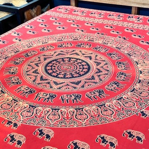 May include: Red tapestry with a black and gold mandala design featuring elephants. The mandala is surrounded by a border of paisley patterns.