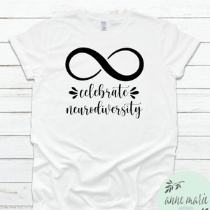 May include: White t-shirt featuring a black infinity symbol and the text "celebrate neurodiversity".