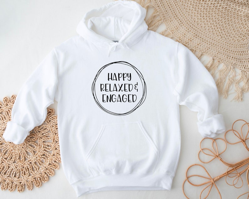 May include: White hooded sweatshirt with the text "Happy Relaxed & Engaged" in a black circle on the front.