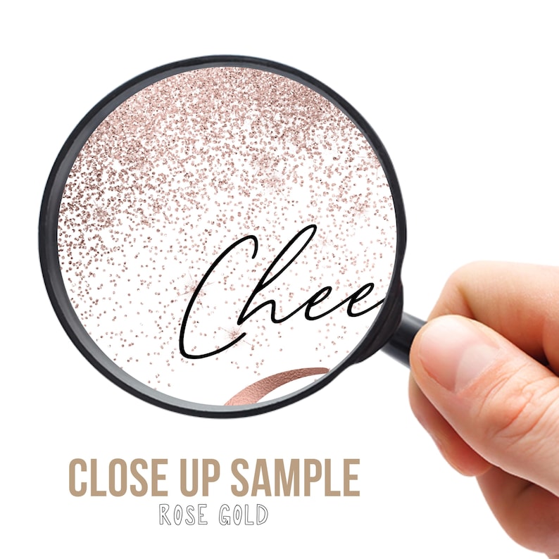 May include: A close-up view through a magnifying glass reveals the word "Chee" in elegant black script, set against a backdrop of rose gold glitter. The words "CLOSE UP SAMPLE ROSE GOLD" are below the magnifying glass.