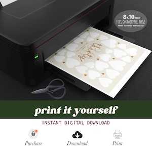May include: A black printer printing a beige sheet with white hearts and gold accents. The text "thirty" is in gold script. The sheet is labeled "8x10 inch fits on normal page". Scissors are in the foreground. The words "print it yourself" are at the bottom.