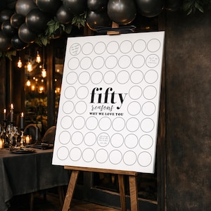 May include: A white sign on a wooden easel with the words "fifty reasons why we love you" in black. The sign has 50 blank circles for writing reasons. Black balloons and candles decorate the background.