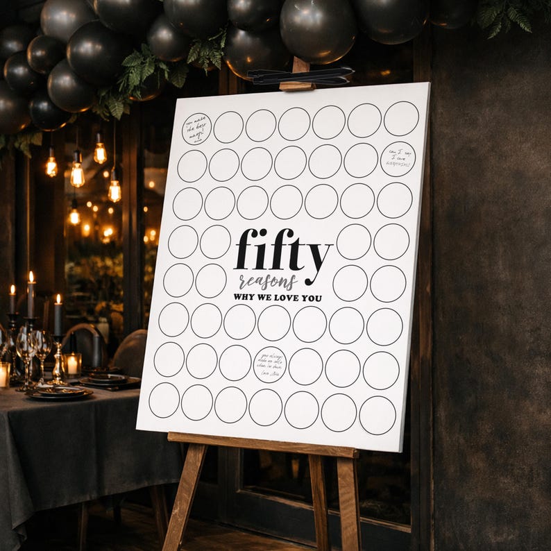 May include: A white sign on a wooden easel with the words "fifty reasons why we love you" in black. The sign has 50 blank circles for writing reasons. Black balloons and candles decorate the background.