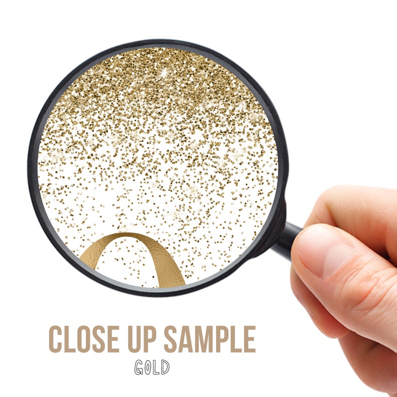 May include: A magnifying glass focused on a white surface covered in fine gold glitter particles, with a curved gold metallic element visible at the bottom. The text CLOSE UP SAMPLE GOLD is printed in a simple sans-serif font below the magnifying glass.