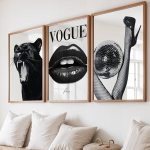 May include: Three framed black and white art prints. One shows a roaring panther, another a pair of glossy lips with the word "Vogue", and the third a leg in a high heel holding a disco ball.