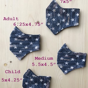 May include: Three face masks with a blue and white star pattern. The masks are labeled with their sizes: Adult Large (7x5 inches), Adult (6.25x4.75 inches), and Child (5x4.25 inches).
